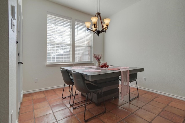 dining room featuring tile patterned flooring and a chandelier