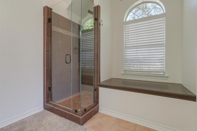 bathroom featuring tile patterned floors and a shower with shower door