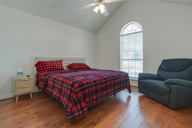 bedroom with dark hardwood / wood-style floors, vaulted ceiling, and ceiling fan