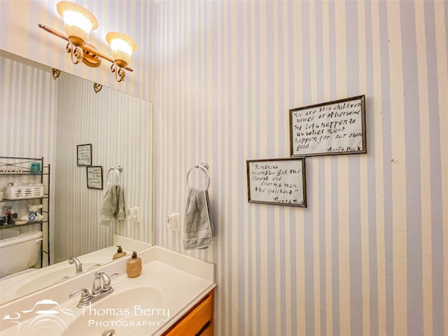 bathroom featuring vanity and toilet