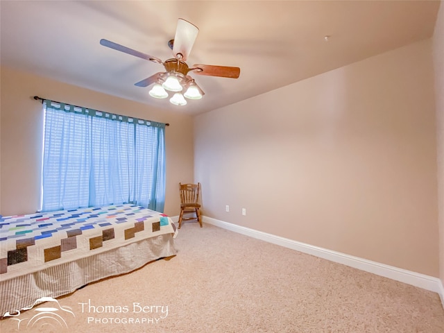 unfurnished bedroom with ceiling fan and carpet