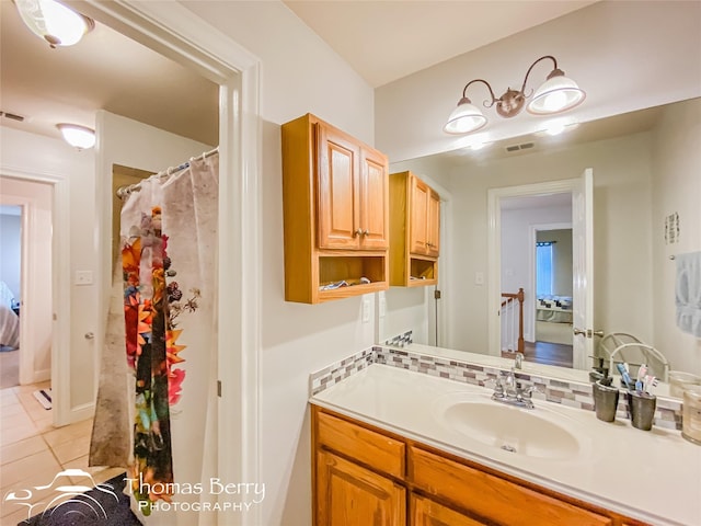 bathroom featuring tile patterned flooring and vanity