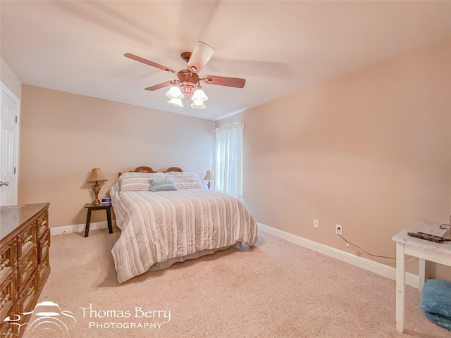 bedroom featuring light colored carpet and ceiling fan