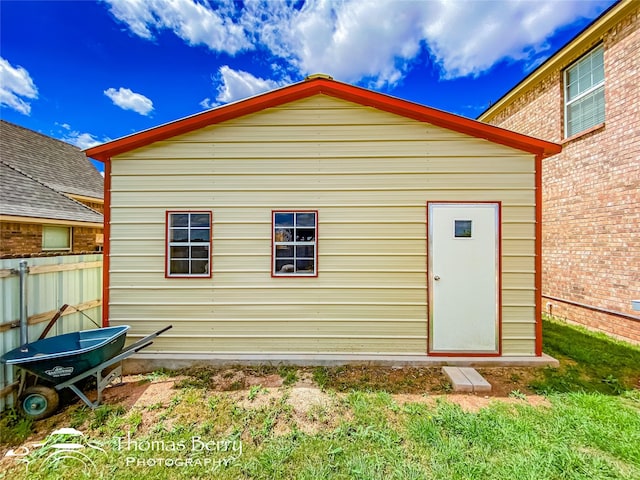 back of house featuring an outbuilding