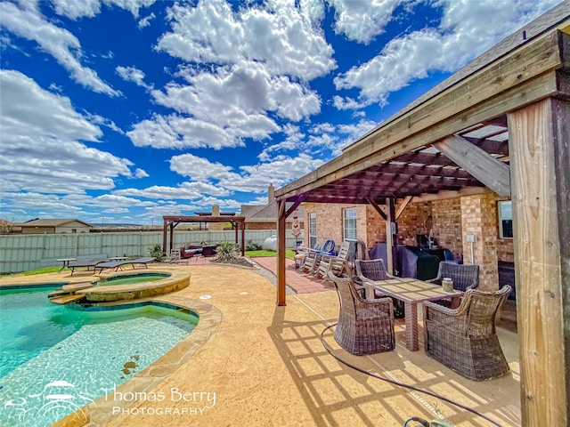 view of pool with a patio area and an in ground hot tub