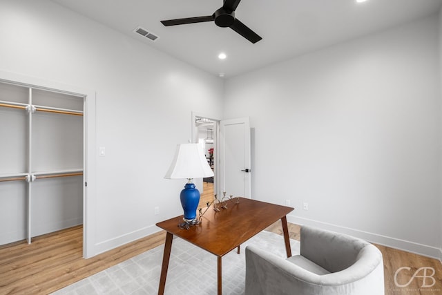 office space with ceiling fan and light hardwood / wood-style flooring