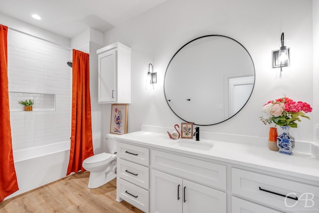 full bathroom with hardwood / wood-style floors, shower / bath combination with curtain, toilet, and vanity