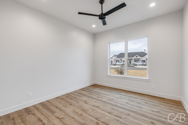 empty room with light hardwood / wood-style flooring and ceiling fan