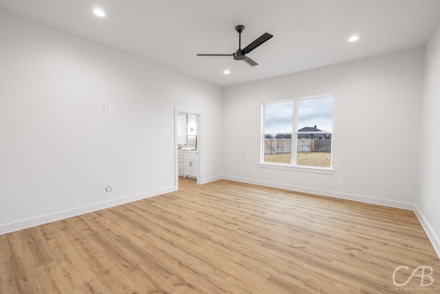 unfurnished room with ceiling fan and light wood-type flooring