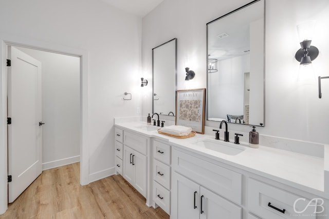 bathroom with hardwood / wood-style floors and vanity