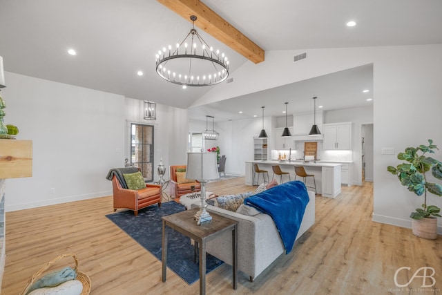 living room with beam ceiling, high vaulted ceiling, light hardwood / wood-style floors, and an inviting chandelier