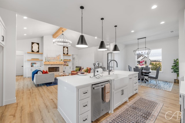 kitchen with white cabinets, a kitchen island with sink, decorative light fixtures, dishwasher, and light hardwood / wood-style floors