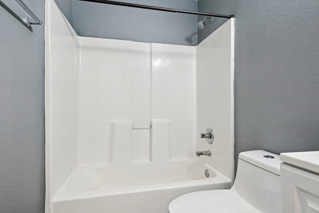 full bathroom featuring vanity, bathing tub / shower combination, and toilet