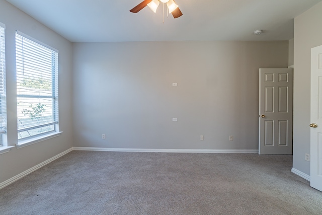 carpeted spare room with ceiling fan