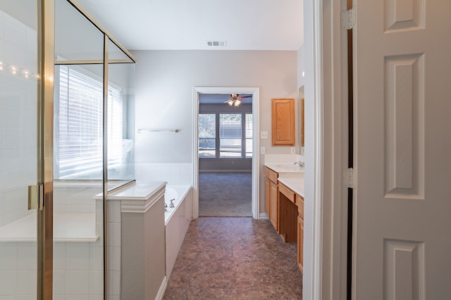 bathroom with ceiling fan, vanity, and shower with separate bathtub