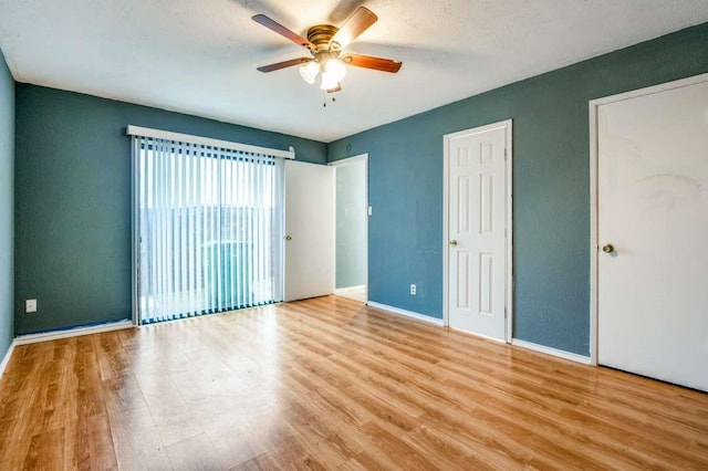 empty room with light wood-type flooring and ceiling fan