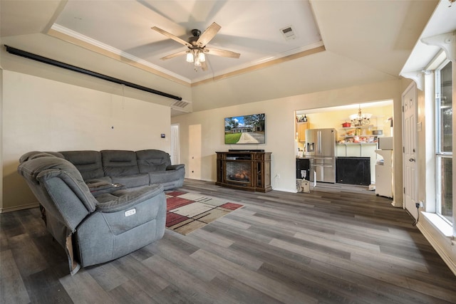 living room with a raised ceiling, a fireplace, ceiling fan, and dark hardwood / wood-style flooring