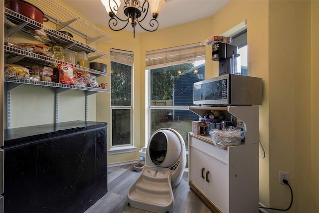 bathroom with a chandelier and hardwood / wood-style flooring