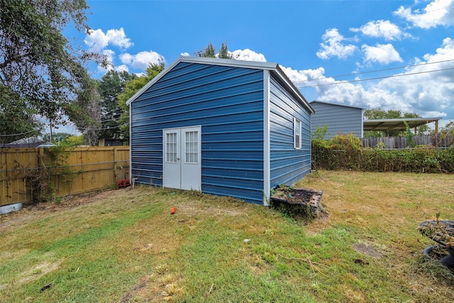 view of outbuilding featuring a lawn