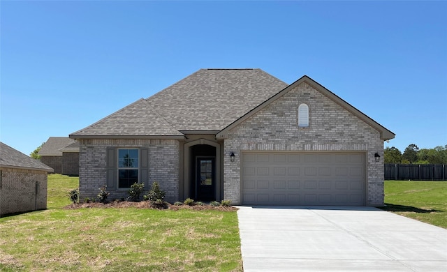 view of front of property featuring concrete driveway, an attached garage, brick siding, roof with shingles, and a front yard
