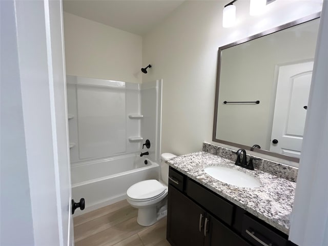 bathroom with shower / washtub combination, vanity, and toilet