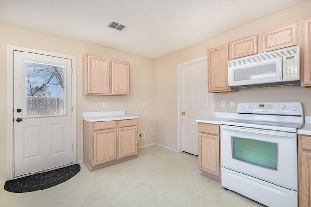 kitchen featuring light brown cabinetry and white appliances