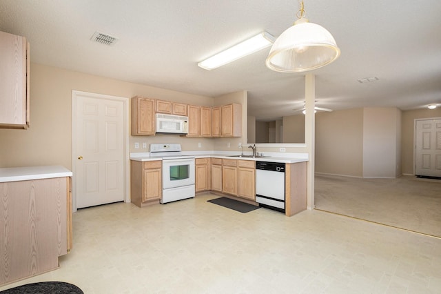 kitchen with pendant lighting, sink, white appliances, and light brown cabinets