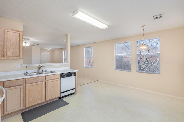 kitchen with white dishwasher, decorative light fixtures, sink, and light brown cabinets