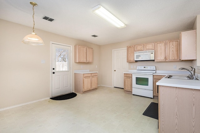 kitchen featuring light brown cabinetry, sink, decorative light fixtures, a textured ceiling, and white appliances