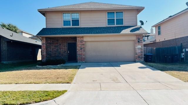 view of front property with a garage and a front yard