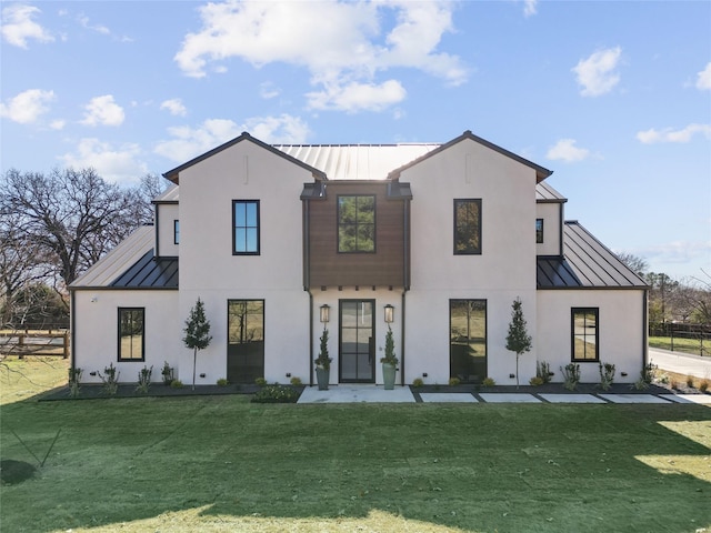 modern farmhouse style home with a front lawn