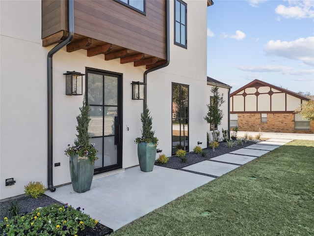 view of exterior entry with a yard