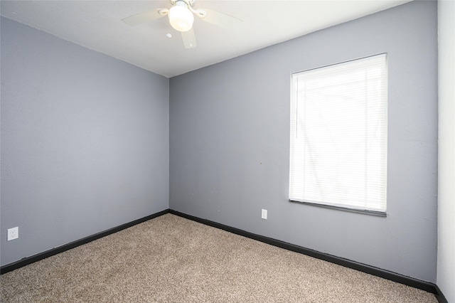 empty room featuring ceiling fan and carpet floors