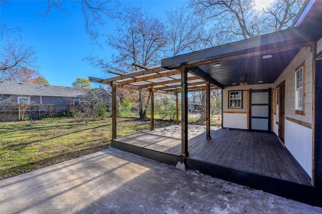 wooden terrace featuring a lawn, a patio, and ceiling fan