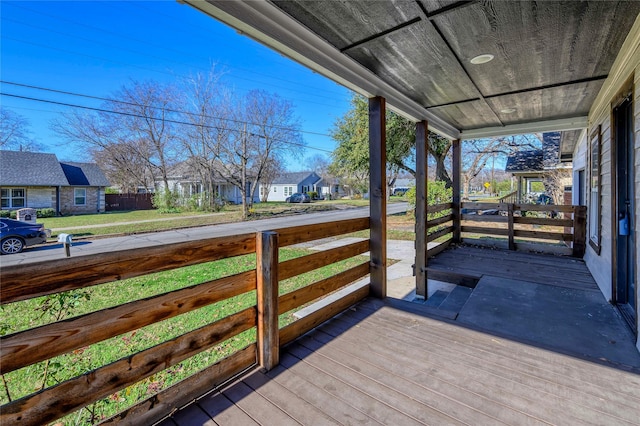 wooden deck featuring a yard and covered porch