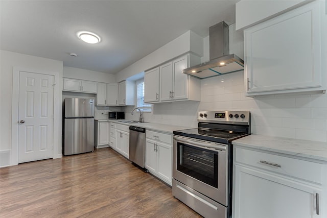 kitchen featuring stainless steel appliances, sink, white cabinets, and extractor fan