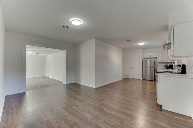 unfurnished living room featuring dark wood-type flooring