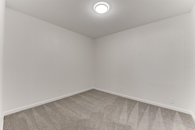 unfurnished room featuring carpet flooring