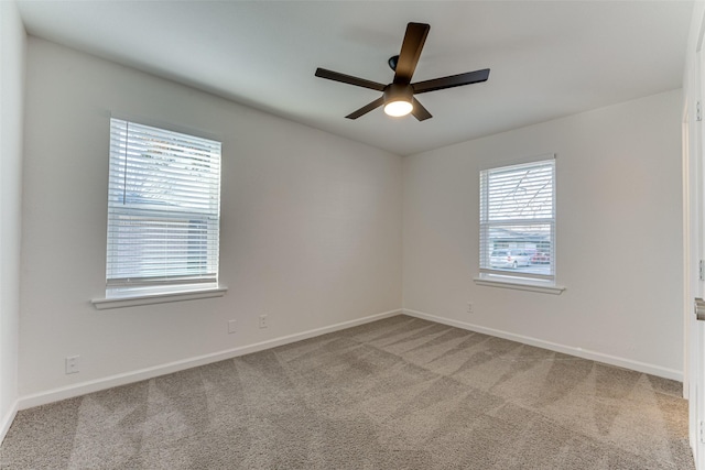 spare room with carpet and ceiling fan