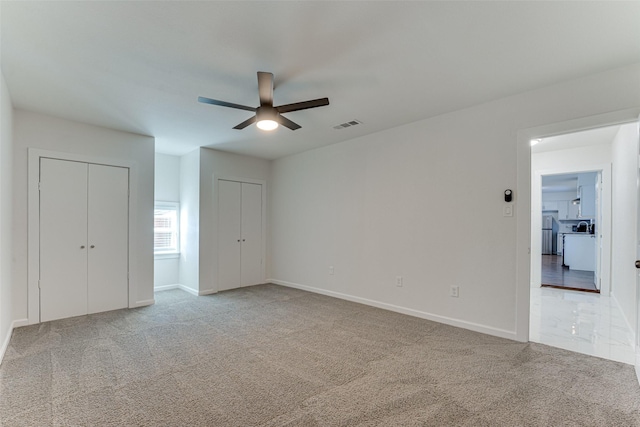 spare room featuring carpet flooring and ceiling fan