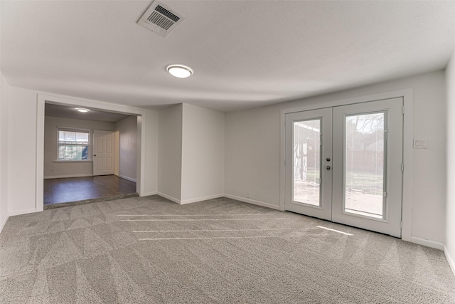 empty room with light carpet and french doors