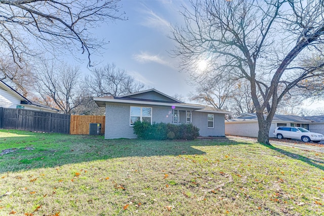 ranch-style home with cooling unit and a front yard