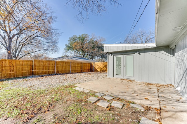 view of yard featuring a patio area and french doors