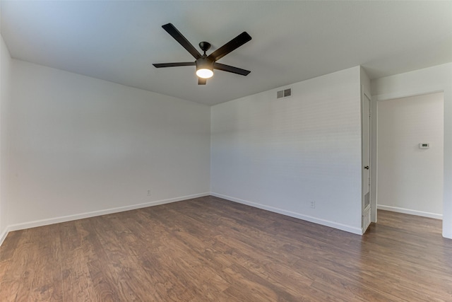 unfurnished room with ceiling fan and dark wood-type flooring