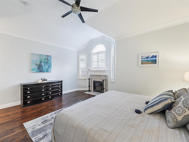 bedroom with ceiling fan, dark wood-type flooring, vaulted ceiling, and ornamental molding