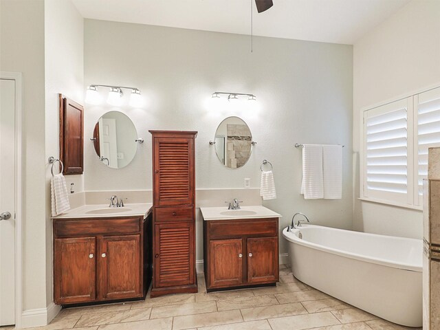 bathroom with vanity, ceiling fan, and a tub