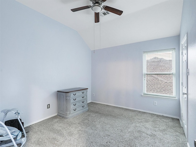 carpeted empty room featuring ceiling fan and lofted ceiling