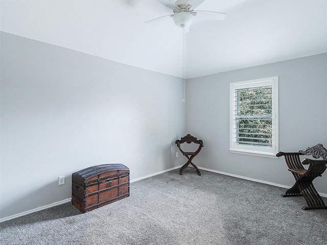 interior space featuring dark carpet, ceiling fan, and lofted ceiling