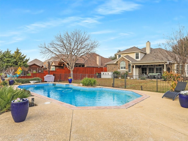 view of pool with a patio and a sunroom