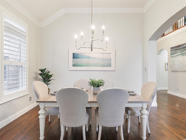 dining space with dark hardwood / wood-style floors, an inviting chandelier, and crown molding